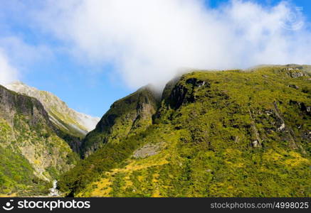 New Zealand. Natural landscape of green mountains and white fog