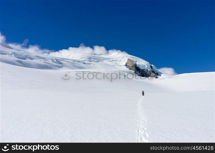 New Zealand. People walking among snows of New Zealand mountains
