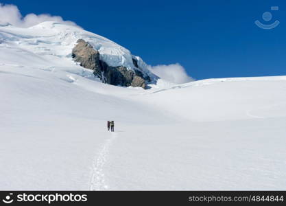 New Zealand. People walking among snows of New Zealand mountains