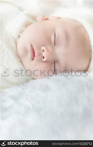 Newborn 30 day old baby boy sleep on a white wrap cloth feelgood relaxing isolated on white background