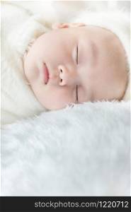 Newborn 30 day old baby boy sleep on a white wrap cloth feelgood relaxing isolated on white background