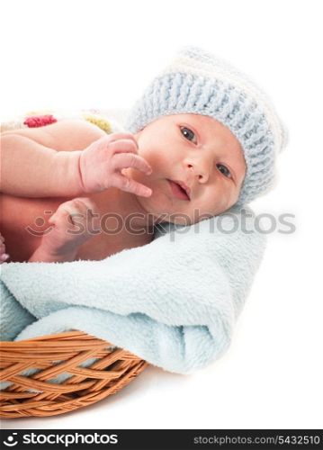 Newborn baby boy in the crochet hat lay in basket