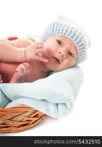 Newborn baby boy in the crochet hat lay in basket