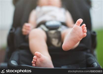 newborn baby feet of baby sitting in carriage or buggy