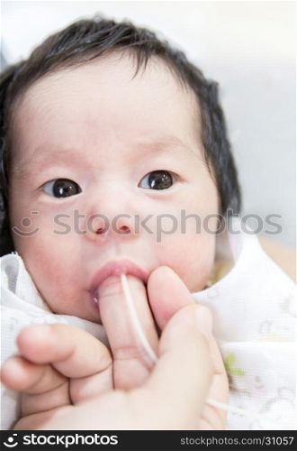 newborn baby Finger Feeding breast milk using tube