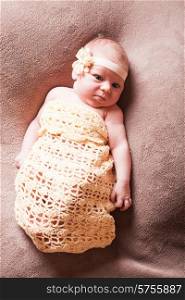 Newborn baby girl on the crochet blanket. Newborn baby