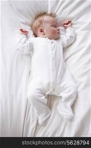 Newborn Baby Girl Sleeping In Bed