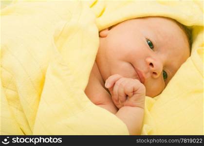 Newborn Baby in the Bed under Yellow Blanket