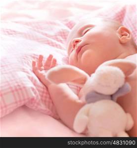 Newborn baby sleeps, relaxing in the bed, adorable healthy child dreaming, safe childhood concept