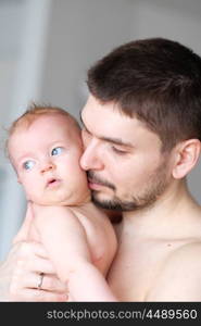 Newborn baby with his father. Shallow depth of field.