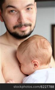 Newborn baby with his father. Shallow depth of field.