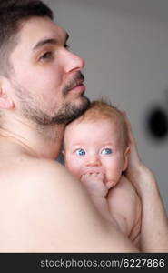 Newborn baby with his father. Shallow depth of field.