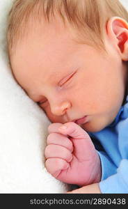 Newborn cute baby sleeping on white blanket