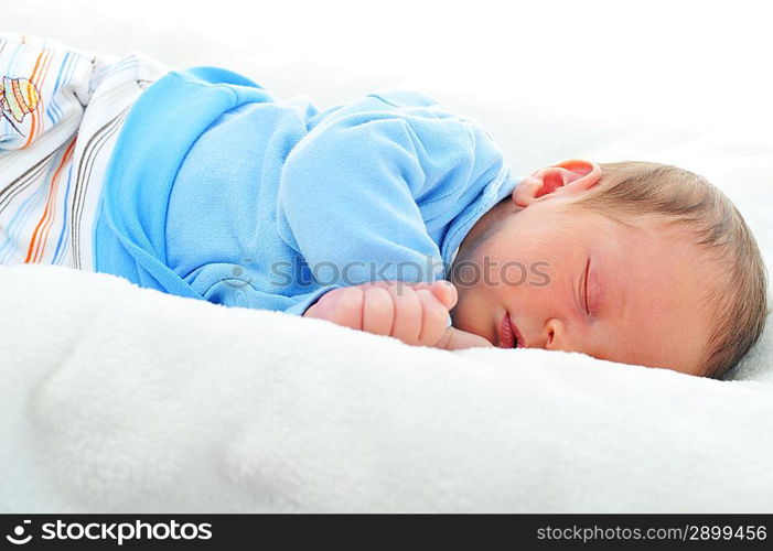 Newborn cute baby sleeping on white blanket