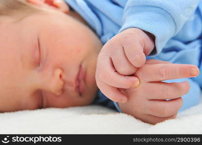 Newborn cute baby sleeping on white blanket