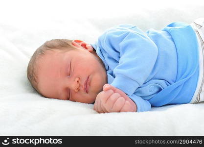 Newborn cute baby sleeping on white blanket