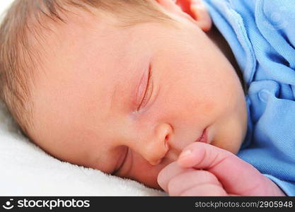 Newborn cute baby sleeping on white blanket