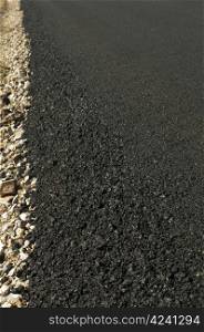 Newly built asphalt road. Close up asphalt coating and breakstone