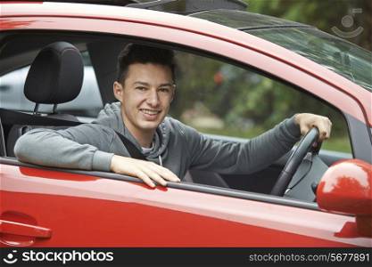 Newly Qualified Teenage Boy Driver Sitting In Car