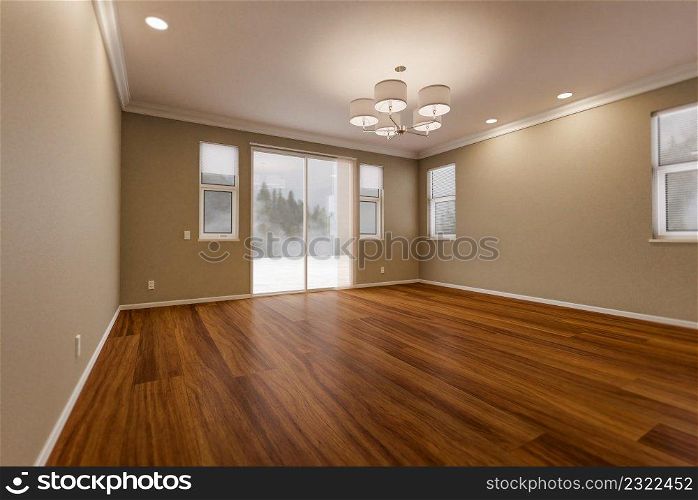 Newly Remodeled Room Of House with Finished Wood Floors, Moulding, Paint and Ceiling Lights.