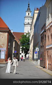 Newly wed couple go on sidewalk