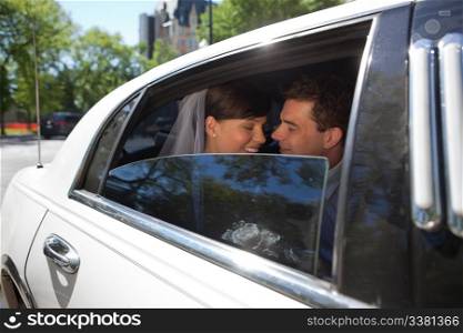 Newly wed romantic couple in car