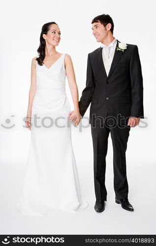 Newlywed couple holding hands