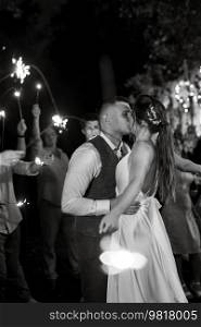 newlyweds at a wedding in the corridor of sparklers