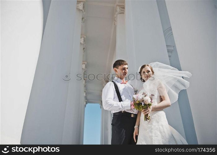 Newlyweds hugging on the background of the Church.. The tender embrace of the newlyweds from the Church 3909.