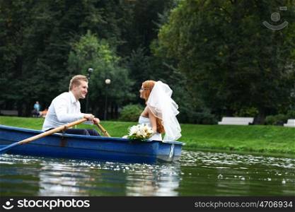 Newlyweds walking paddle boating in the park