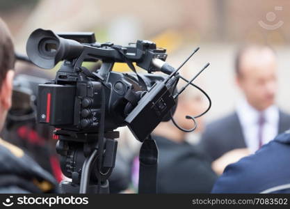 News conference. Covering an event with a television camera.