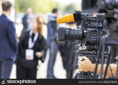 News conference or media interview. Shooting press event with a television camera.