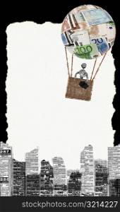 Newspaper figurine of a man in a hot air balloon over buildings
