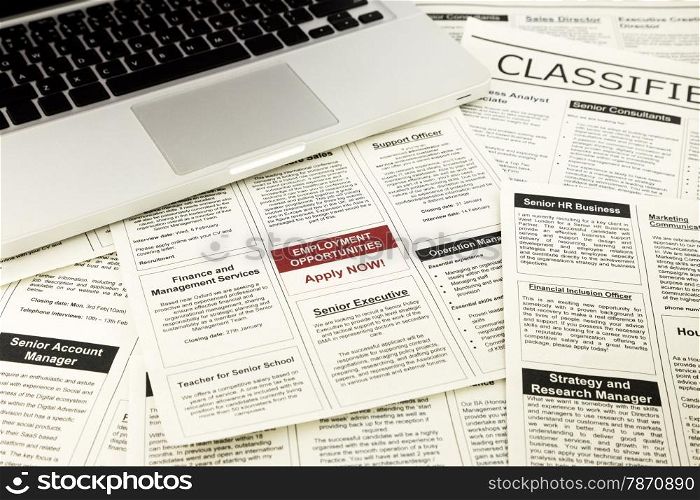 newspaper with advertisements and classifieds ads for vacancy, job search and apply now