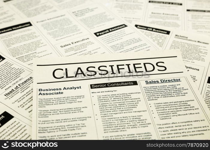 newspaper with advertisements and classifieds ads for vacancy, search for jobs