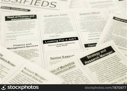 newspaper with advertisements and classifieds ads for vacancy, search for jobs