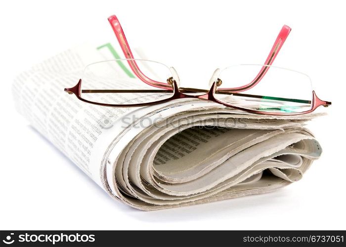 newspaper with glasses over a white background