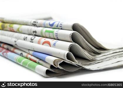 Newspapers folded and stacked isolated on white