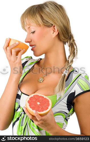 nice and young girl with green dress and braid hair smelling grapefruit