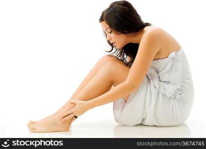 nice and young woman in bathrobe taking care of herself on white background