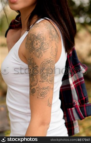 Nice arm profile of a brunette woman showing her tattoo