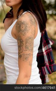 Nice arm profile of a brunette woman showing her tattoo