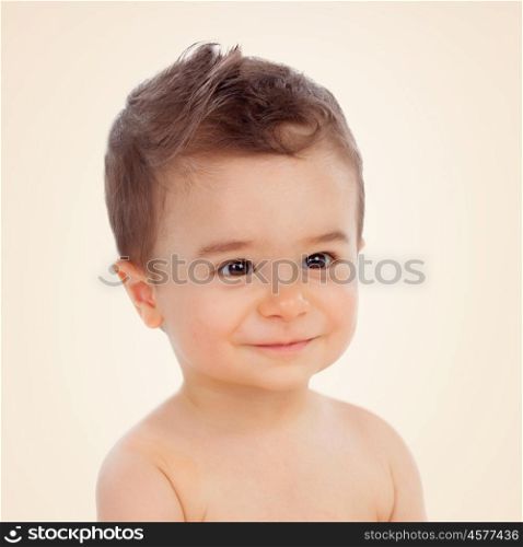 Nice baby with brown eyes smiling on a yellow background