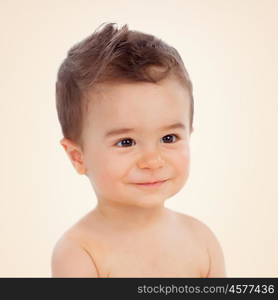 Nice baby with brown eyes smiling on a yellow background