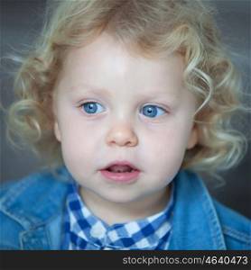 Nice blond baby with blue eyes and curly hair