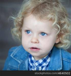 Nice blond baby with blue eyes and curly hair