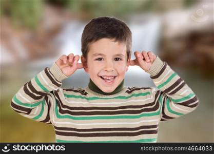 Nice boy covering the ears with unfocused background