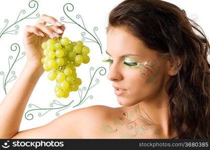 nice brunette with bodypaint and green eyelashes looking a grape