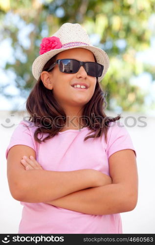 Nice child girl ten year old with a hat on the street