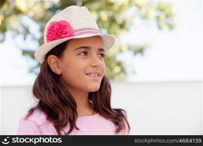 Nice child girl ten year old with a hat on the street